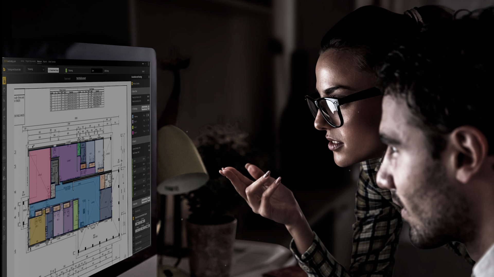 a man and woman looking at a computer sfe rite estimating screen