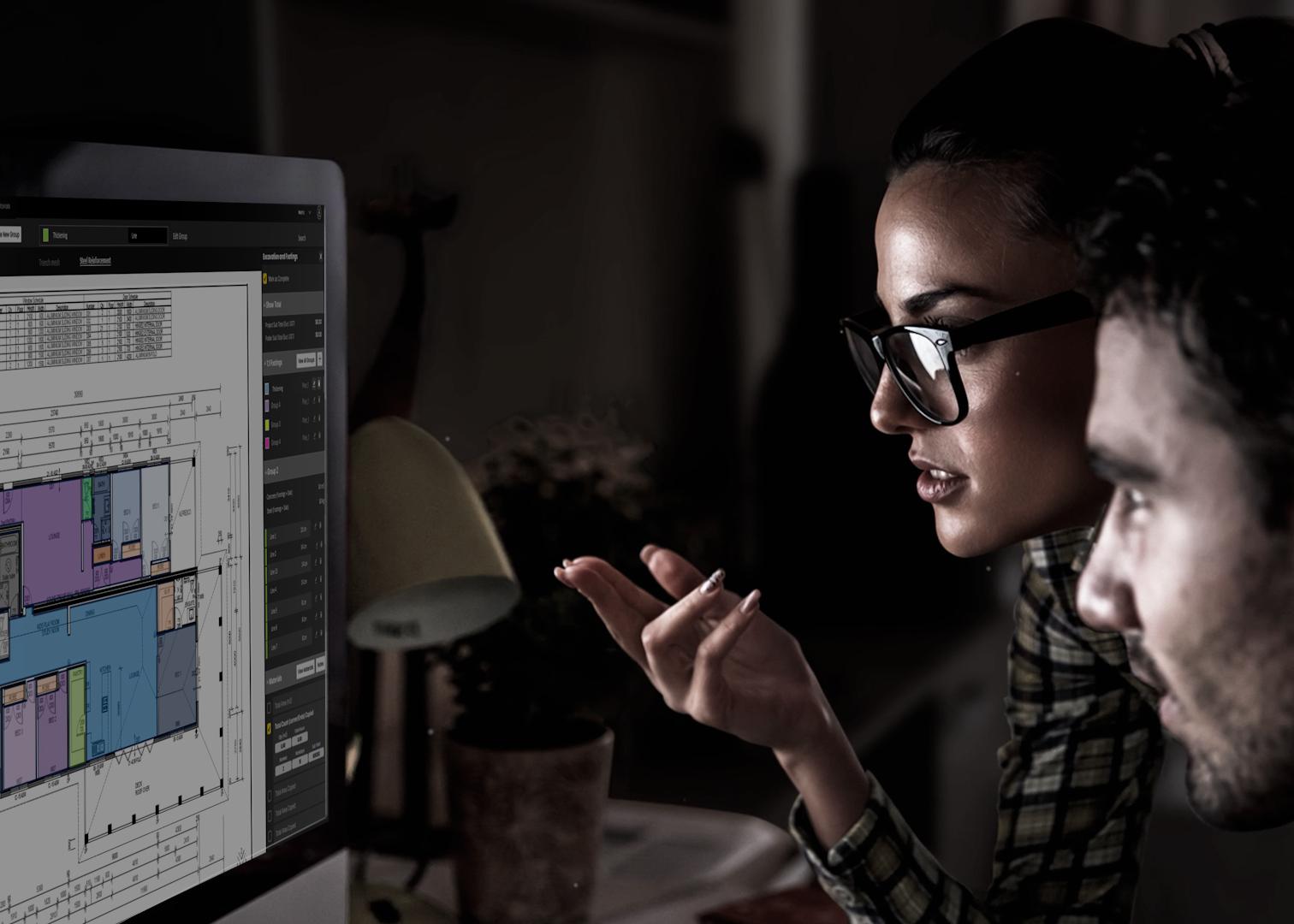 a woman and man looking at a computer screen